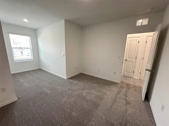 a view of a swimming pool and lounge chairs