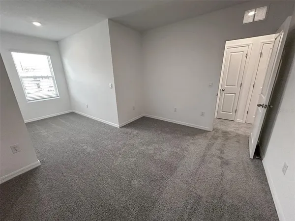 an aerial view of a house with a garden and lake view