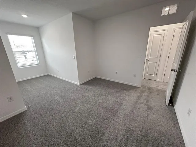 an aerial view of a house with a garden and lake view