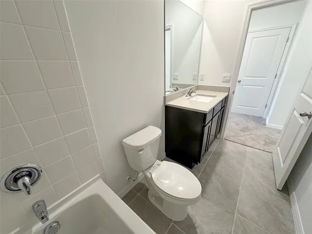 an aerial view of a house with garden space and street view