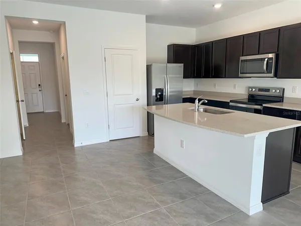 a kitchen with stainless steel appliances a sink stove and cabinets