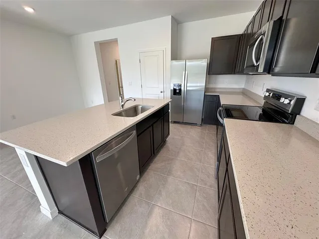 a kitchen with a sink and a refrigerator
