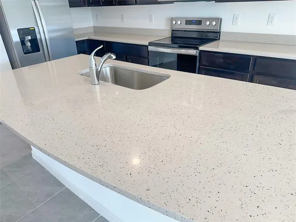 a kitchen with metallic refrigerator freezer and a dishwasher
