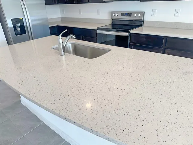a kitchen with metallic refrigerator freezer and a dishwasher