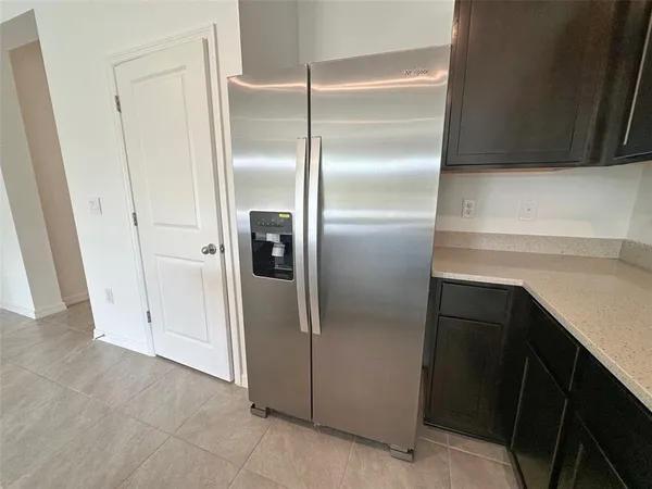 a kitchen with metallic refrigerator freezer and a dishwasher