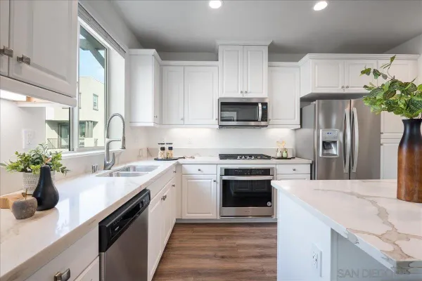 a kitchen with a sink stove and refrigerator