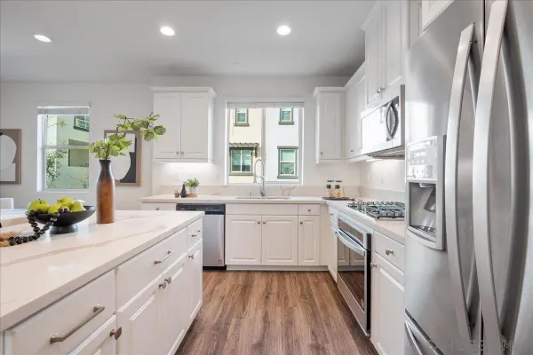 a kitchen with a sink stove and refrigerator