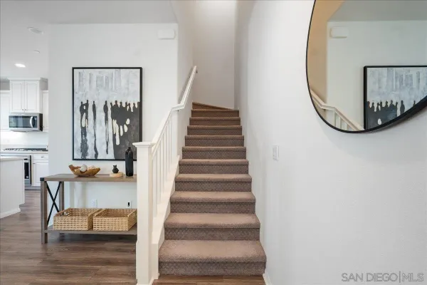 a view of entryway and hall with wooden floor