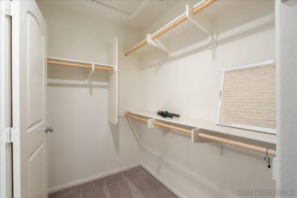 a room with rack on the wall and a window