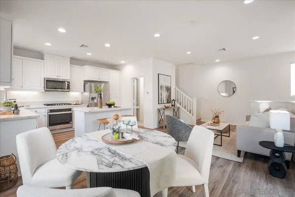 a living room with furniture and kitchen view