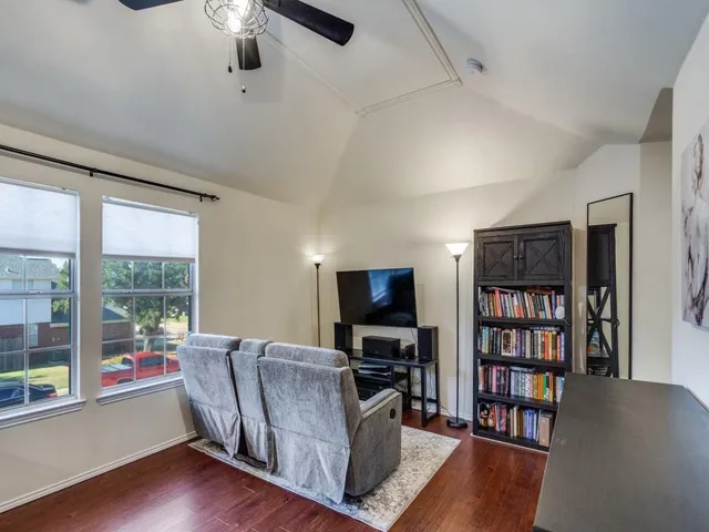 a living room with fireplace furniture and a flat screen tv