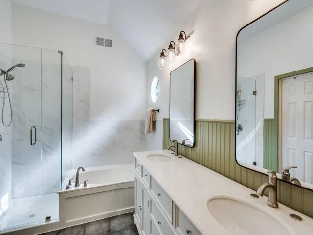 a bathroom with a double vanity sink mirror and double