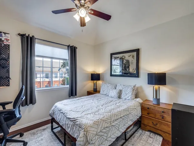 a bedroom with a large bed and a window