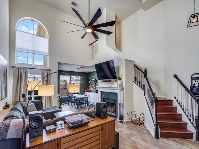 a living room with furniture a fireplace and a flat screen tv