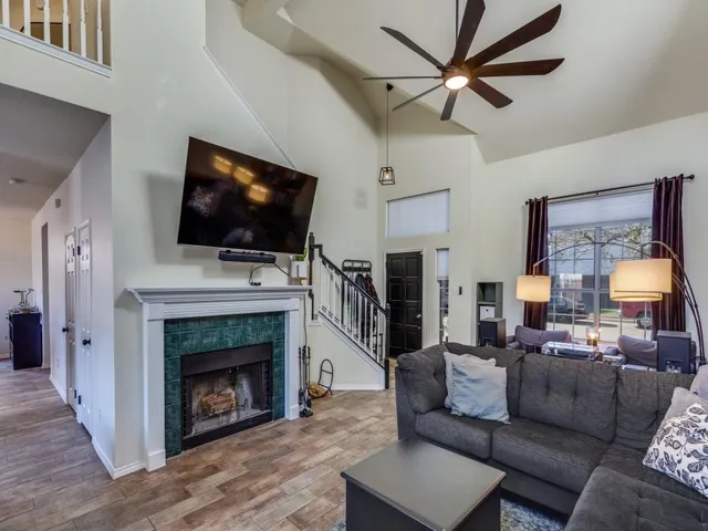 a living room with furniture a fireplace and a flat screen tv