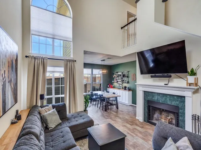 a living room with furniture a fireplace and a flat screen tv