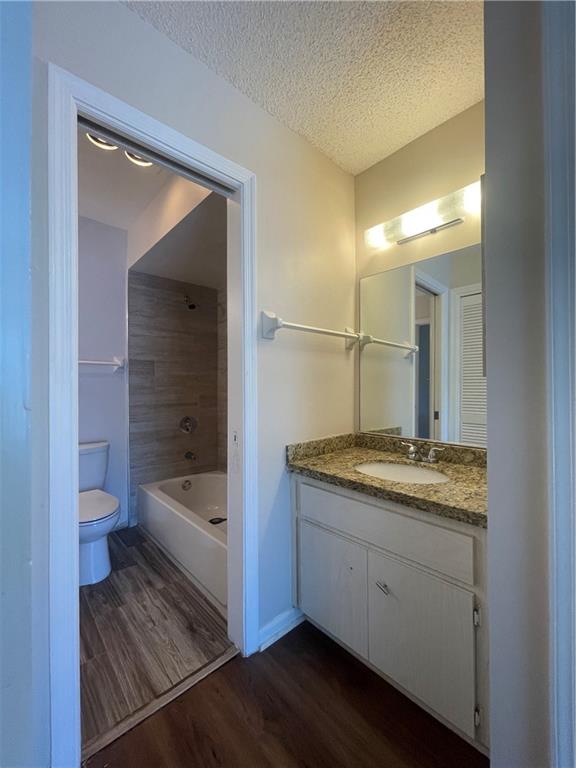 3601 Northeast 22nd Avenue Lighthouse Point, FL 33064 - Photo 11 of 13 a bathroom with a granite countertop sink a toilet and bathtub