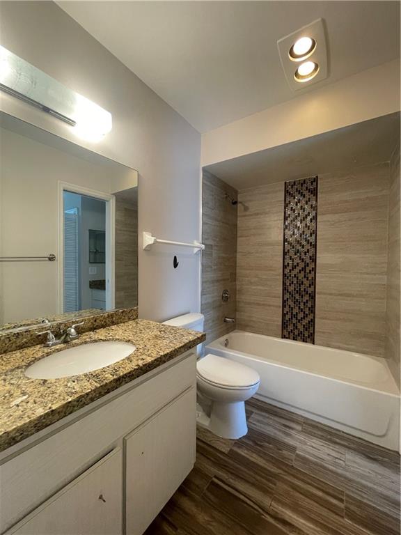3601 Northeast 22nd Avenue Lighthouse Point, FL 33064 - Photo 10 of 13 a bathroom with a granite countertop toilet a sink and a bathtub