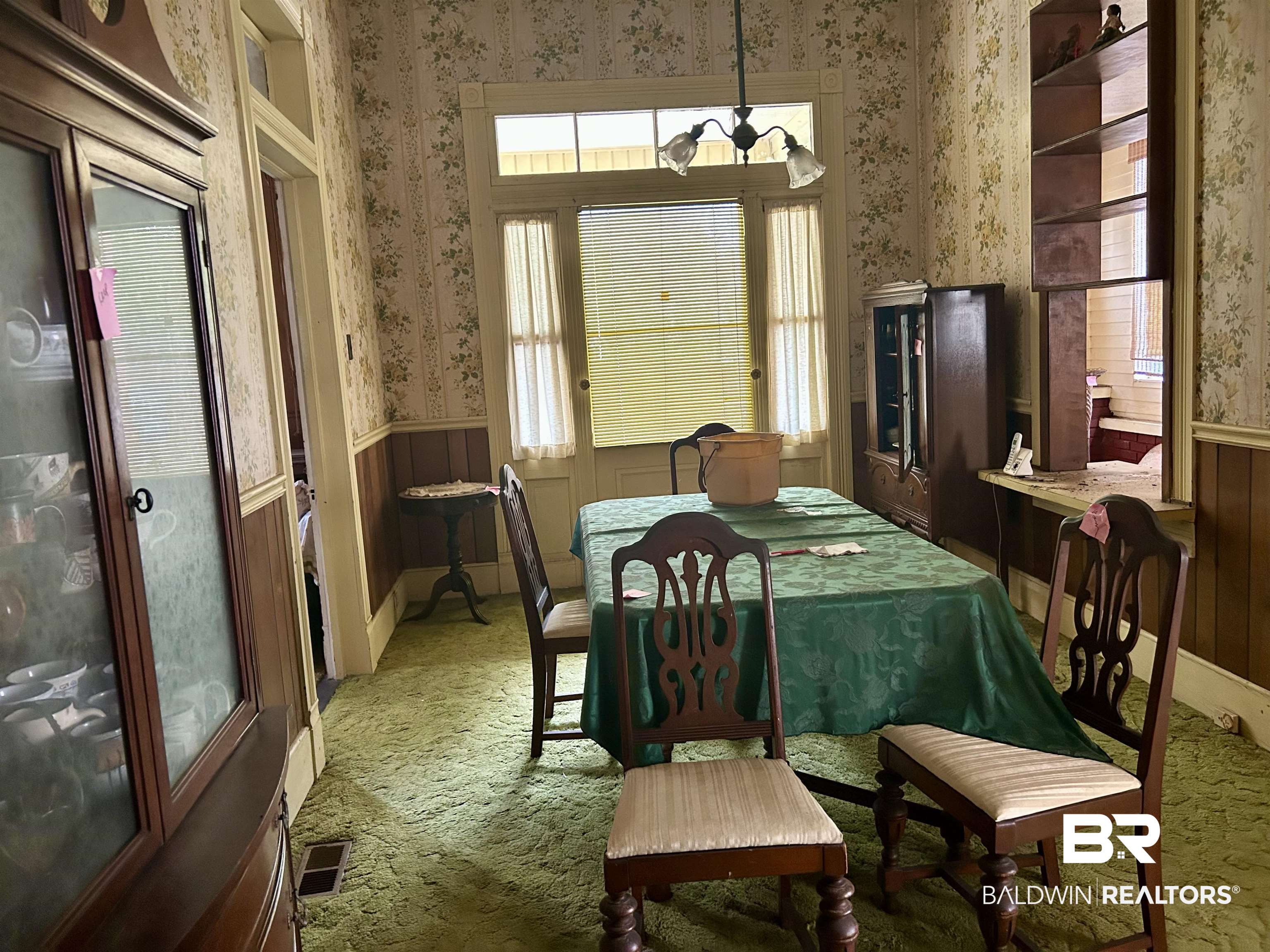 302 Stocking Street Mobile, AL 36604 - Photo 22 of 31 Room featuring patterned wallpaper, wainscoting, and green carpeting