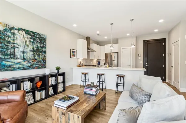 a living room with furniture and a book shelf