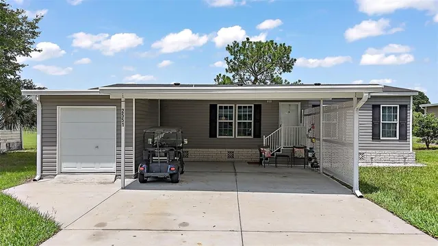 a front view of house with a chair and tables