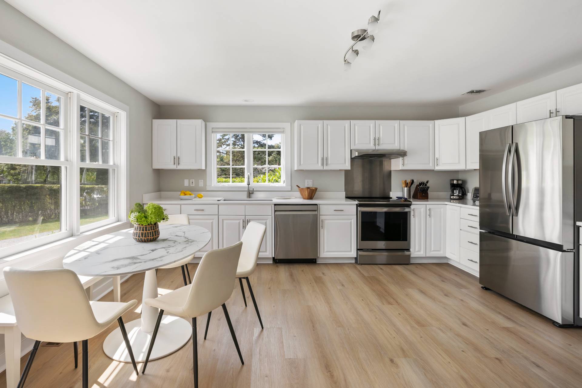 10 Aelfie's Way Bridgehampton, NY 11932 - Photo 14 of 31 a kitchen with granite countertop stainless steel appliances a refrigerator a stove a dining table and chairs