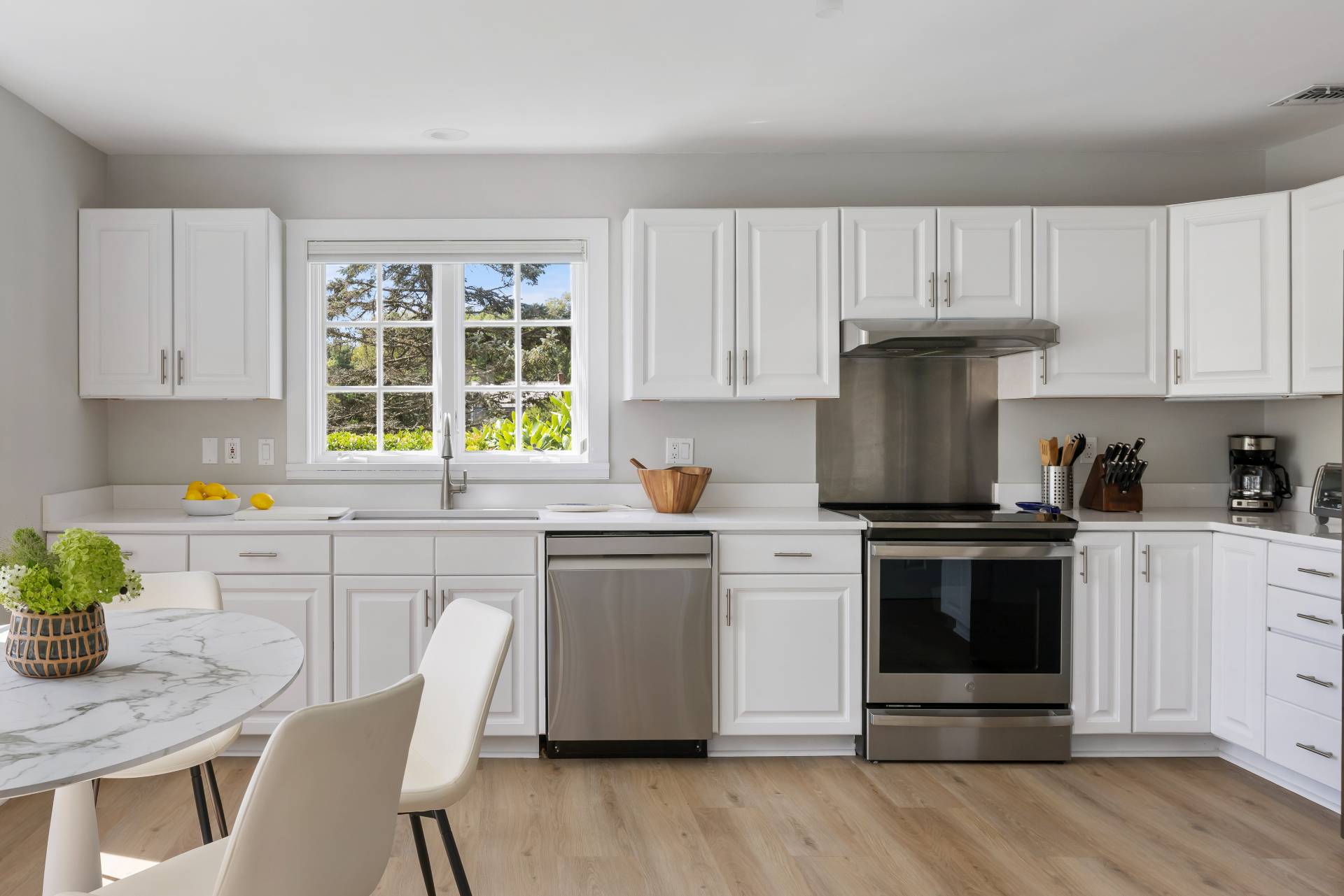 10 Aelfie's Way Bridgehampton, NY 11932 - Photo 16 of 31 a kitchen with granite countertop white cabinets and white appliances