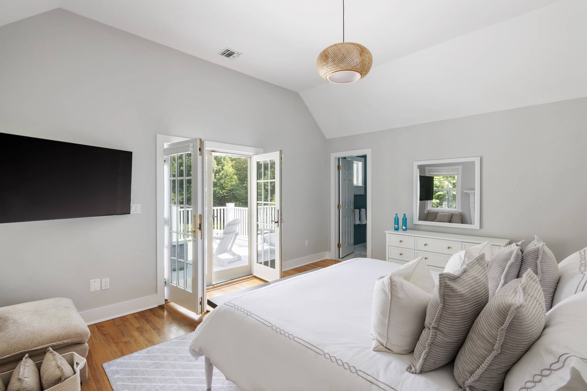 10 Aelfie's Way Bridgehampton, NY 11932 - Photo 20 of 31 a bedroom with a large bed and a flat tv screen on dresser