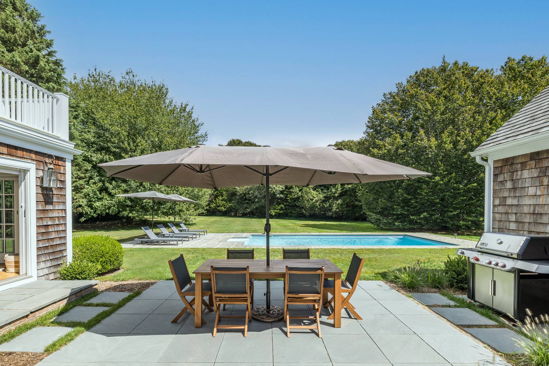 10 Aelfie's Way Bridgehampton, NY 11932 - Photo 3 of 31 a view of a table and chairs under an umbrella
