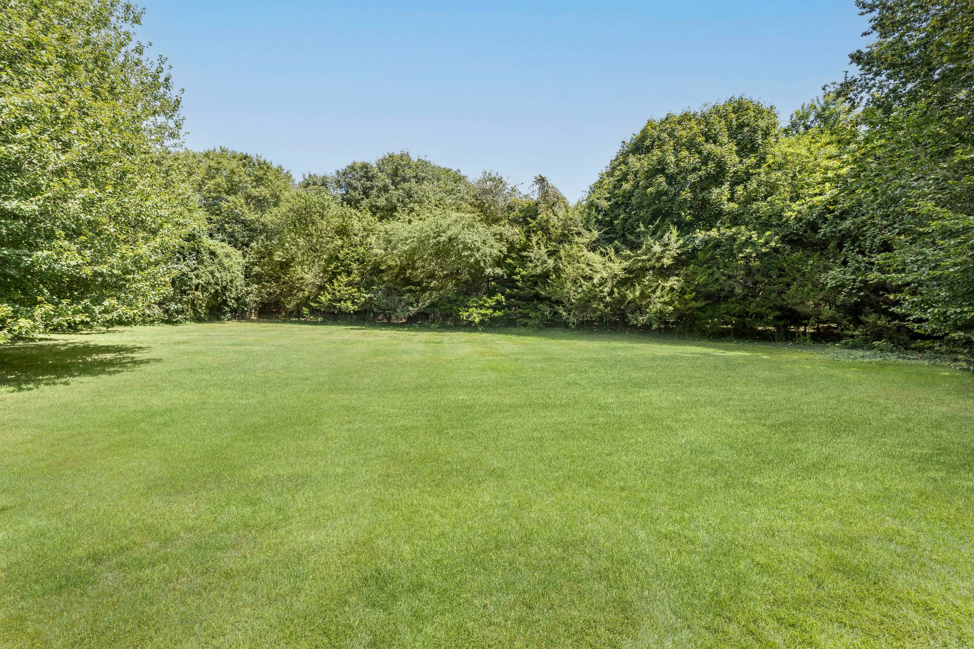 10 Aelfie's Way Bridgehampton, NY 11932 - Photo 9 of 31 a view of a green field with trees in the background