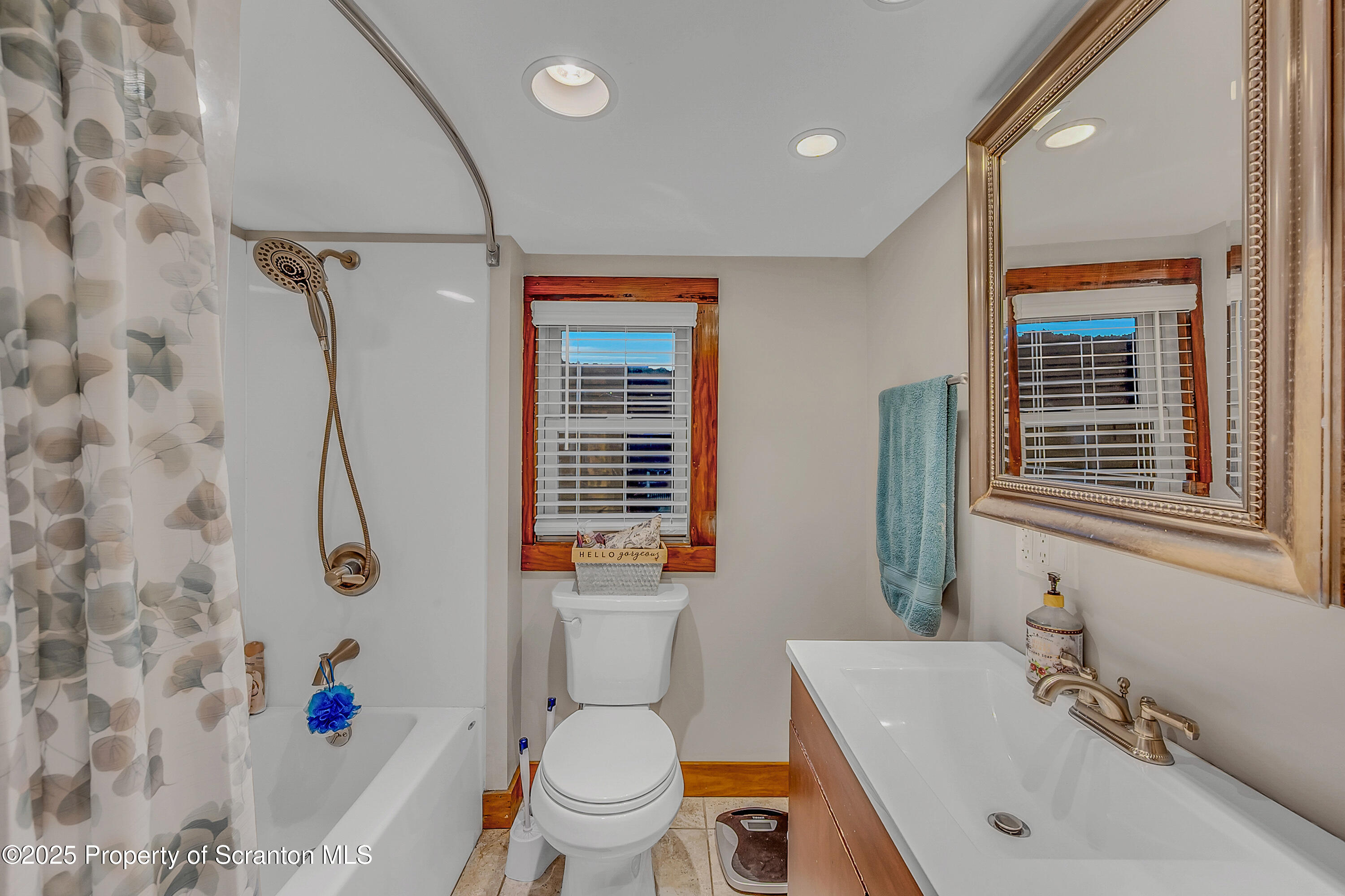 191 Ash Street Archbald, PA 18403 - Photo 20 of 28 a bathroom with a sink a toilet and shower curtain