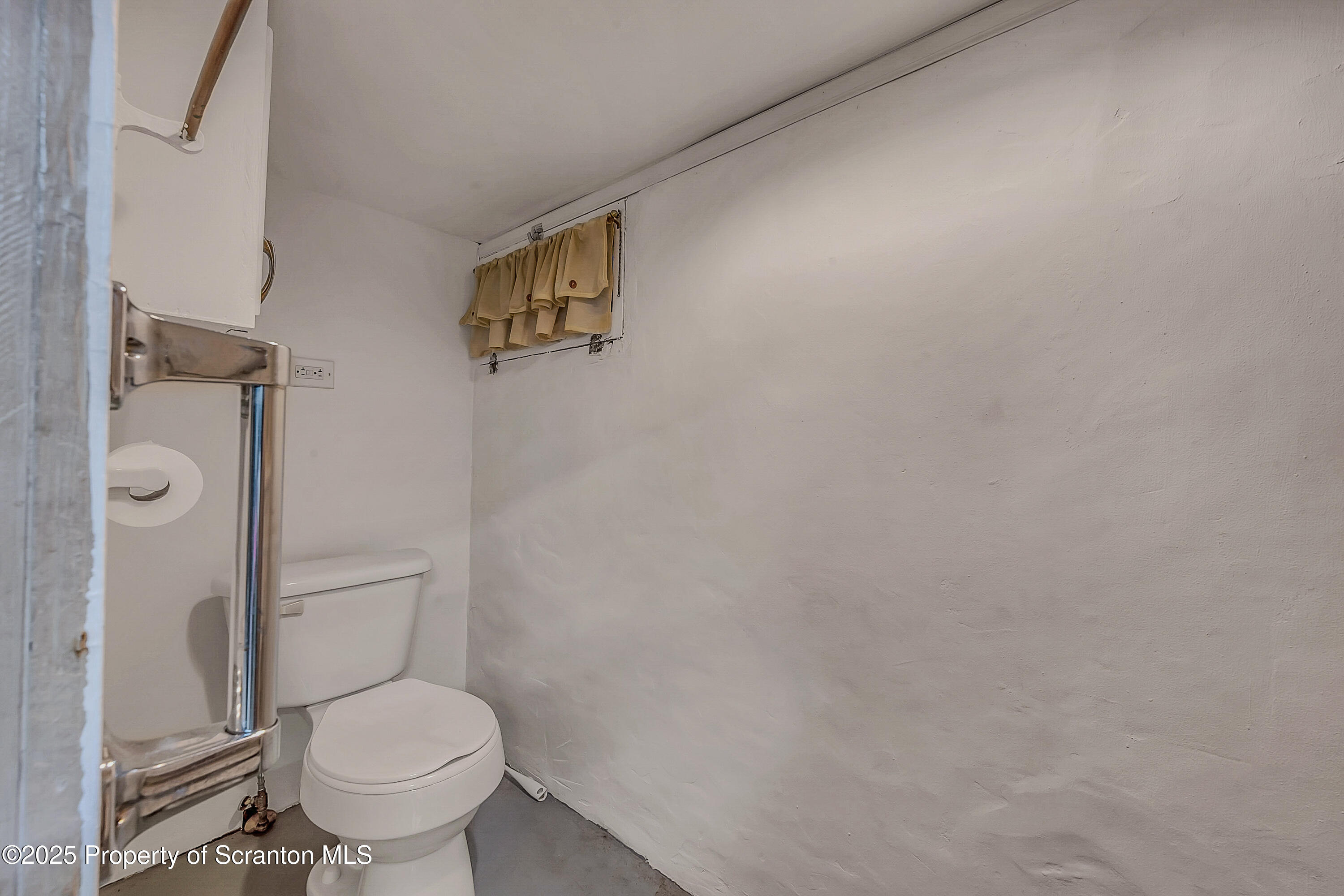191 Ash Street Archbald, PA 18403 - Photo 21 of 28 a white toilet sitting next to a shower curtain