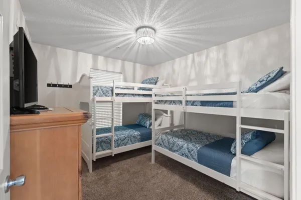 a bedroom with a bed and a chandelier