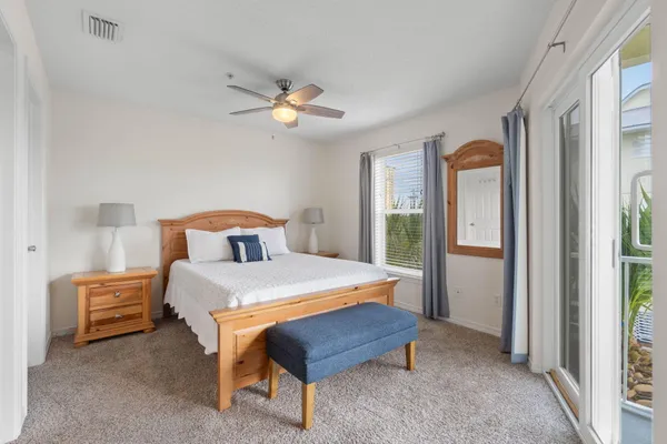 a bedroom with a large bed and a ceiling fan