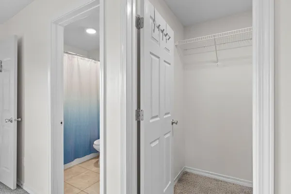 a bathroom with a granite countertop sink toilet a mirror and shower