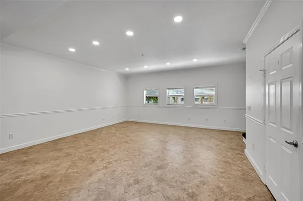 an empty room with a empty space and windows