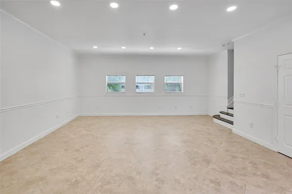 an empty room with a empty space and windows