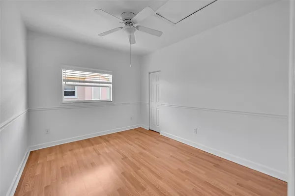 a view of a room with wooden floor and white walls