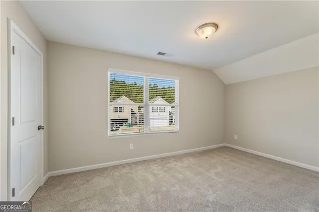 a bathroom with a granite countertop double vanity sink and a mirror
