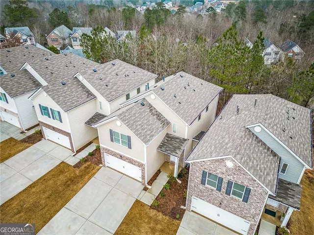 an aerial view of a house with balcony and outdoor space