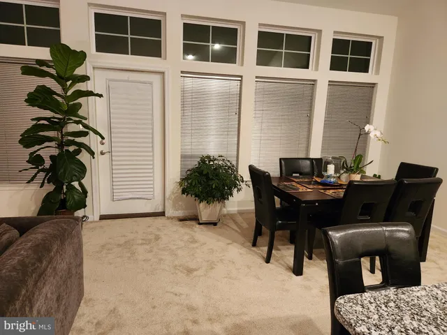 a view of a dining room with furniture and window