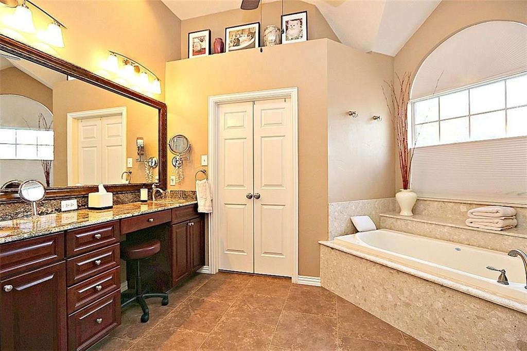 14588 Poe Court Addison, TX 75001 - Photo 16 of 28 a spacious bathroom with a tub sink and mirror