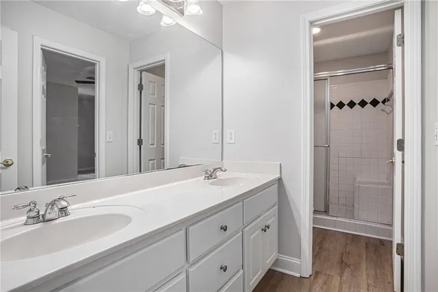 a bathroom with a granite countertop sink shower and a mirror