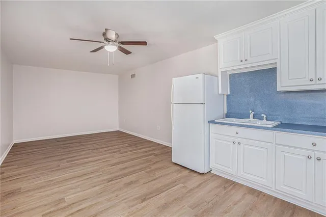 a view of a kitchen with wooden floor