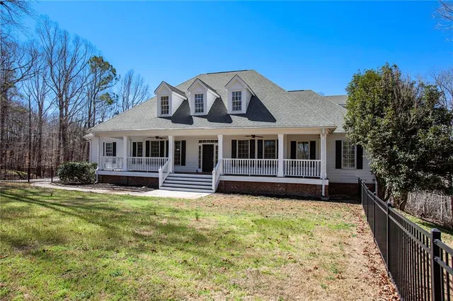 a front view of a house with a garden and porch