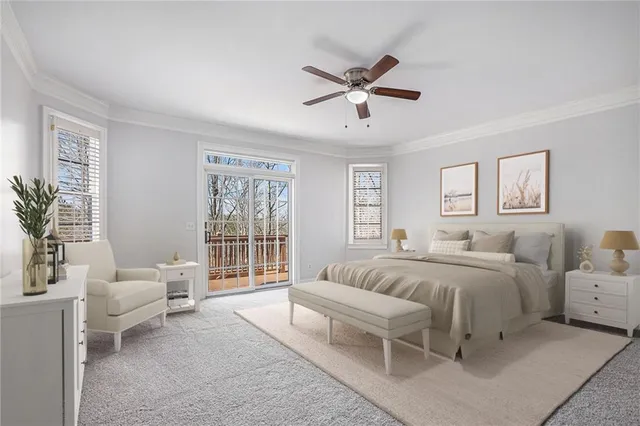 a spacious bedroom with a bed a couch and potted plant on the dresser