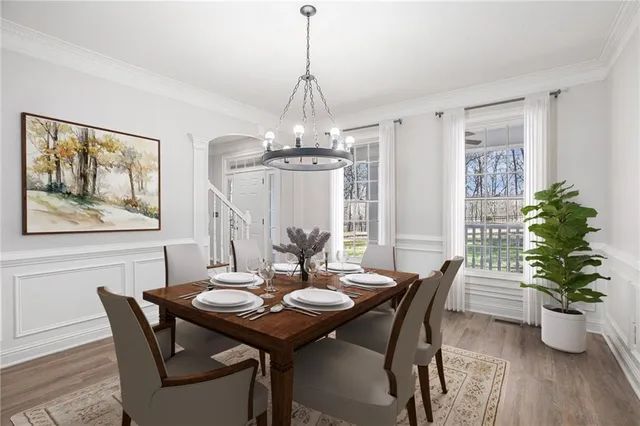 a view of a dining room with furniture window and wooden floor