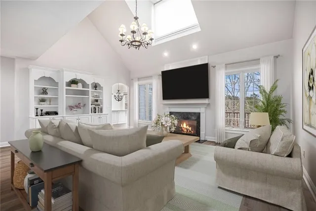 a living room with furniture a fireplace and a flat screen tv