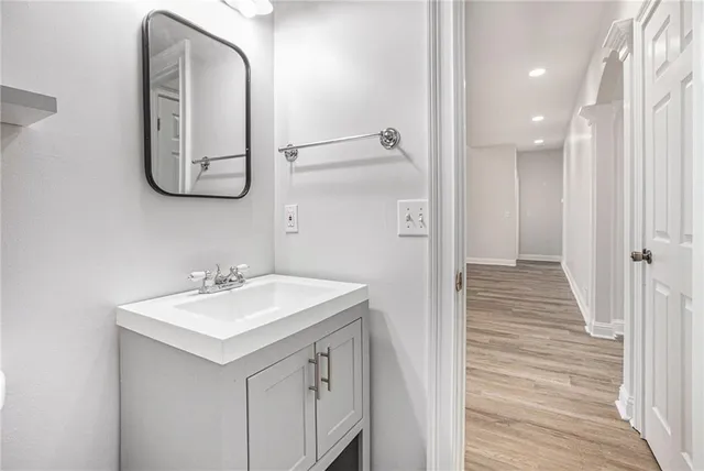 a bathroom with a sink a mirror and vanity