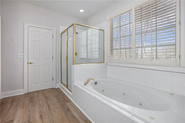 a bathroom with a bathtub a toilet and a shower